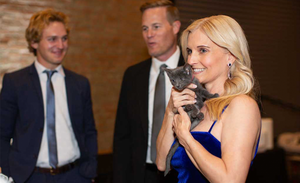 Women holding a grey kitten at Hope Gala 2024